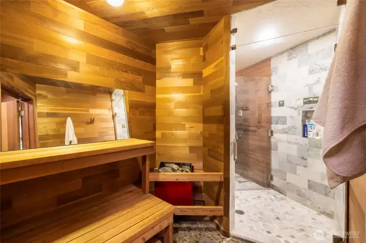 The spa-like en suite offers dual walk-through cedar-lined dressing rooms, a dedicated soaking tub, a beautifully tiled shower, and direct access to a private, cedar-lined sauna. The spa-like en suite offers dual walk-through cedar-lined dressing rooms, a dedicated soaking tub, a beautifully tiled shower, and direct access to a private, cedar-lined sauna.