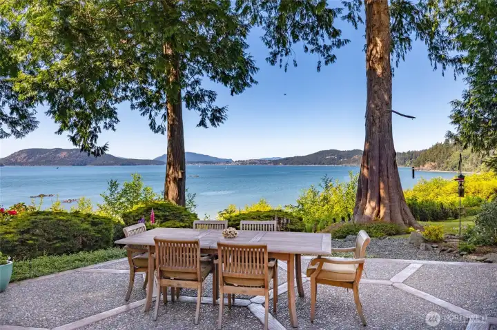 Transition effortlessly outdoors to over 2,000 square feet of aggregate patio, leading down to 140+/- feet of pristine shoreline. Transition effortlessly outdoors to over 2,000 square feet of aggregate patio, leading down to 140+/- feet of pristine shoreline.