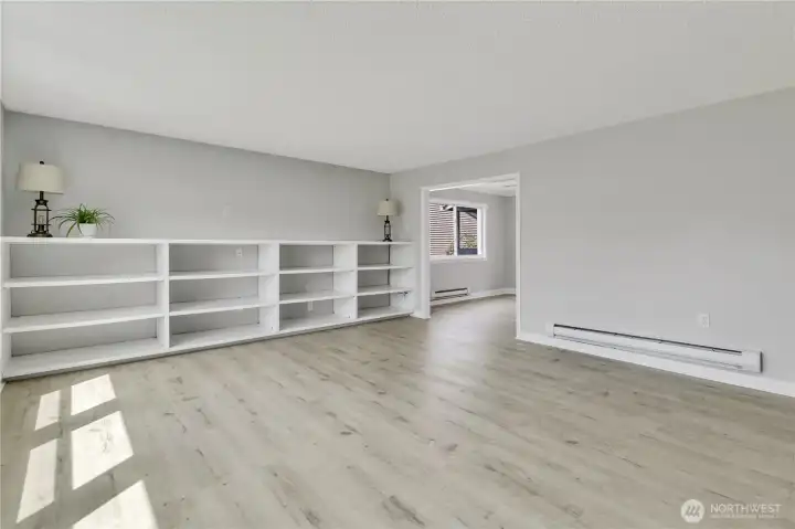 The living room is accessible to both the dining room and the kitchen for easy flow gatherings and entertaining.