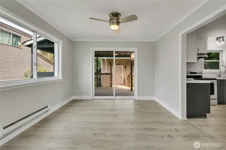 Light-filled dining room with a slider to the expansive deck makes entertaining effortless.