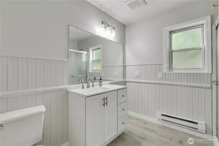 Updated 3/4 bath with classic wainscoting that adds warmth and character.