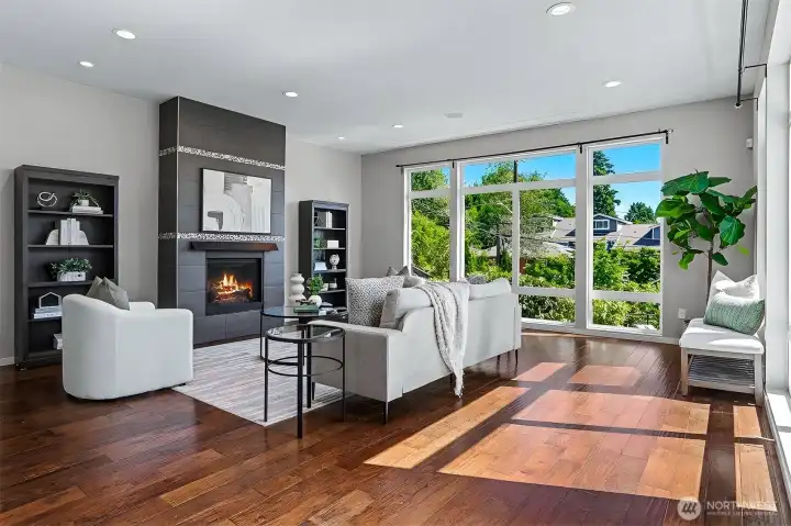 Spacious living room features a beautiful tile surround gas fireplace and floor-to-ceiling windows. Spacious living room features a beautiful tile surround gas fireplace and floor-to-ceiling windows.