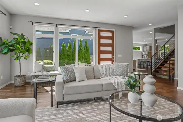 Living room flows effortlessly past the floating staircase and into the kitchen & dining area. Living room flows effortlessly past the floating staircase and into the kitchen & dining area.