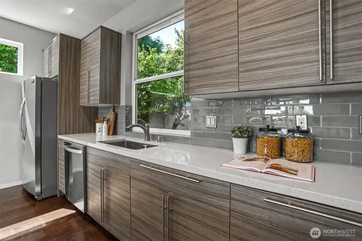 Kitchen features soft-close cabinets & drawers and quartz countertops, tied together by the beautiful tile backsplash. Kitchen features soft-close cabinets & drawers and quartz countertops, tied together by the beautiful tile backsplash.