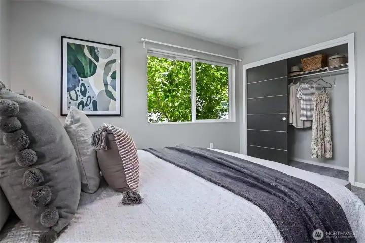 One of two guest bedrooms upstairs. Wall hanging and closet are virtually staged. One of two guest bedrooms upstairs. Wall hanging and closet are virtually staged.