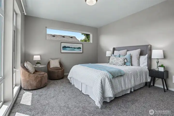 The second of two guest bedrooms upstairs. This one features floor-to-ceiling windows. The second of two guest bedrooms upstairs. This one features floor-to-ceiling windows.