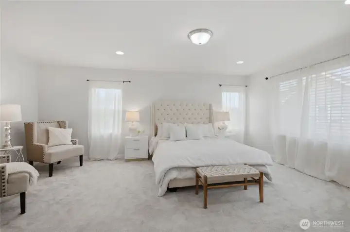 Elegant primary suite has room for a sitting area and is flooded with light!