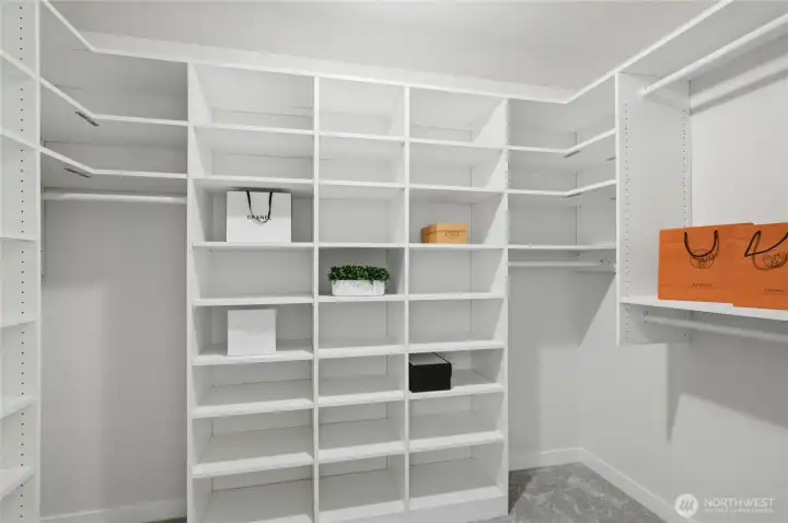 Primary walk in closet with custom closet built-ins!