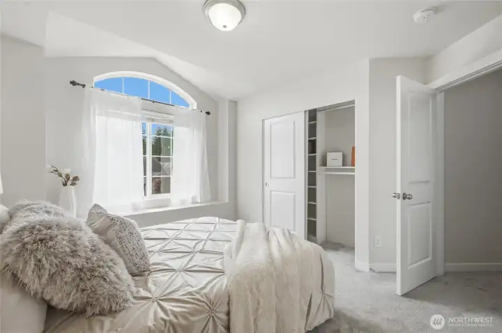 Additional bedroom with arched window.