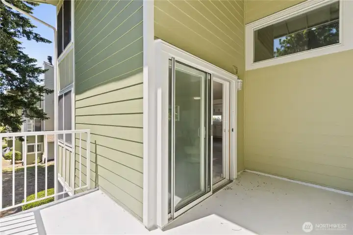 Large Windows for natural light + Partially covered Deck through double glass sliders