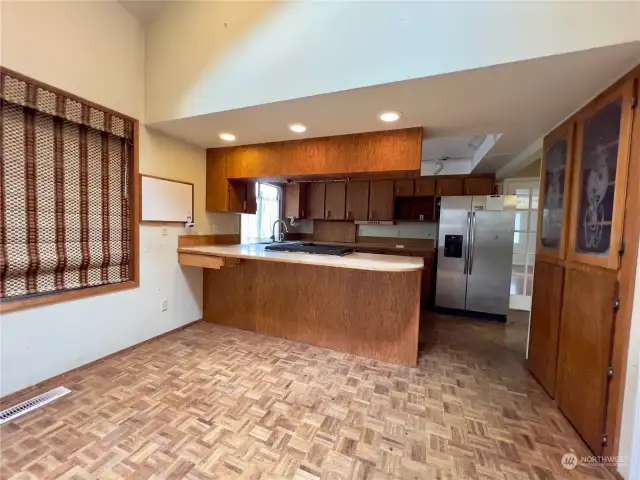 Dining Room adjacent to kitchen with parquet flooring.