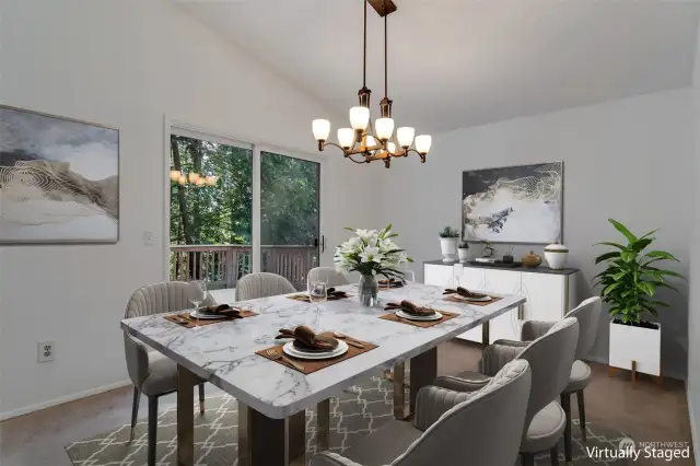Lovely staged photo of dining room, overlooking backyard deck.