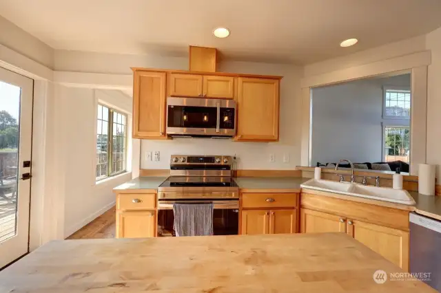 Large kitchen with stainless appliances and handy island, The door to the left goes to the back deck, fenced back yard and patio.