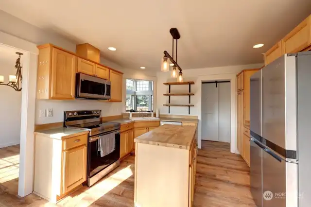 Large kitchen with stainless appliances and handy island, The doorway to the left goes to the formal dining room.