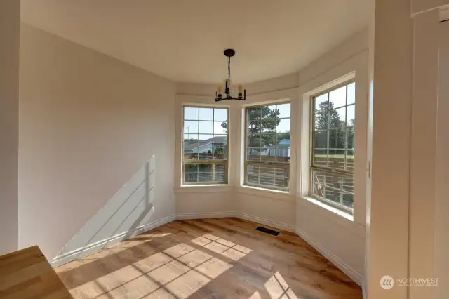 The breakfast nook is in the background overlooking the fenced back yard and patio.