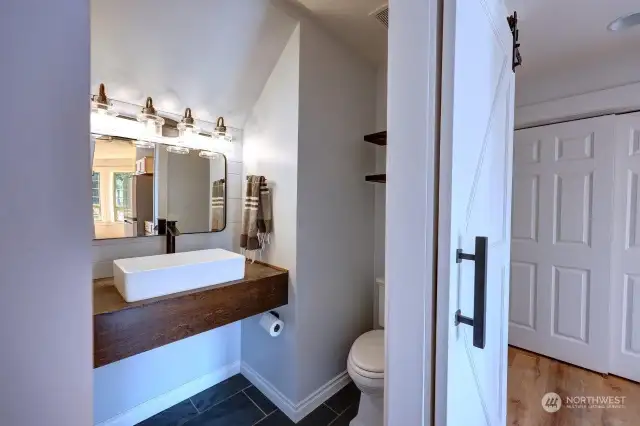 Main floor half bath just off the living room and kitchen