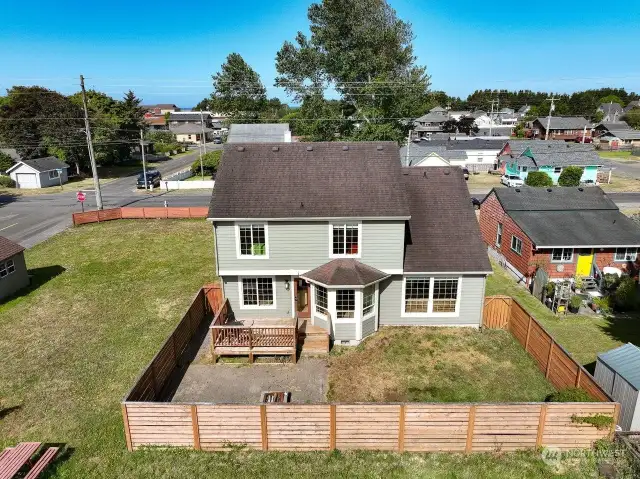 The fenced back yard is set up for entertaining and fur babies. Complete with fire pit, concrete patio and raised deck.