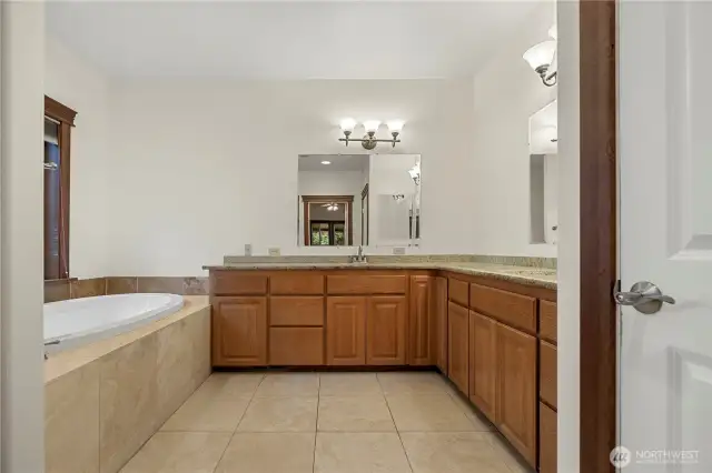 Primary Bath with dual sinks walk in shower and jetted tub.
