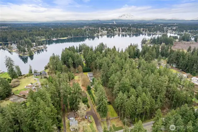 Aerial Shot showing Spanaway lake and Mt Rainier and surrounding area.  This home is center of photo with gated entrance