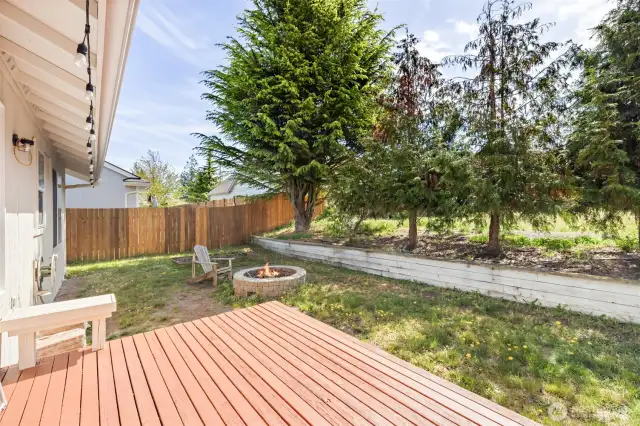 Backyard with firepit adjacent to Com. green space