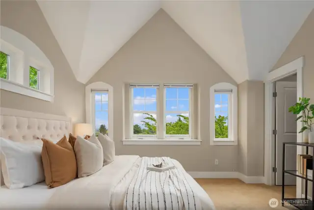 Enjoy splendid views of the Bellevue skyline and the Cascades mountains from this bedroom that also features a walk in closet, en suite and private den.