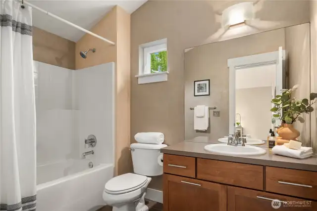The spacious full bath off the 2nd bedroom features a full tub, vaulted ceilings and a large vanity.