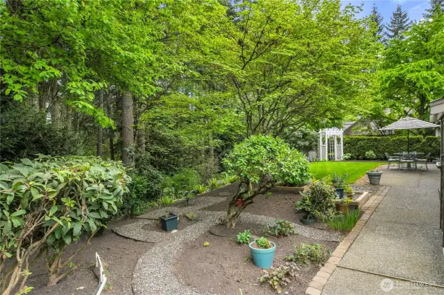 Rain Bird® replaced in 2023: two zones in front and two zones in back. Convenient, extended aggregate walkway from front to back. Storage shed in back. Private back yard with garden arbor. Raised garden beds.