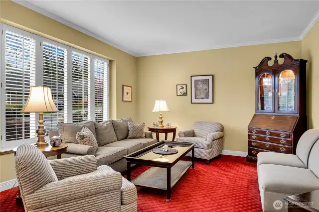 Formal living room. 9-foot ceiling with crown molding. Rich, designer carpet. Divided light windows with two-inch Plantation style shutters.
