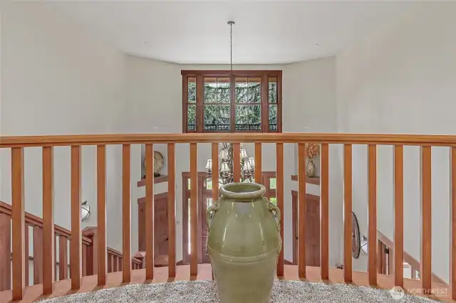 The upstairs hallway looks down into the entrance.