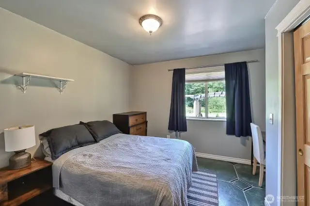 Bedroom with a view of the backyard and back patio.
