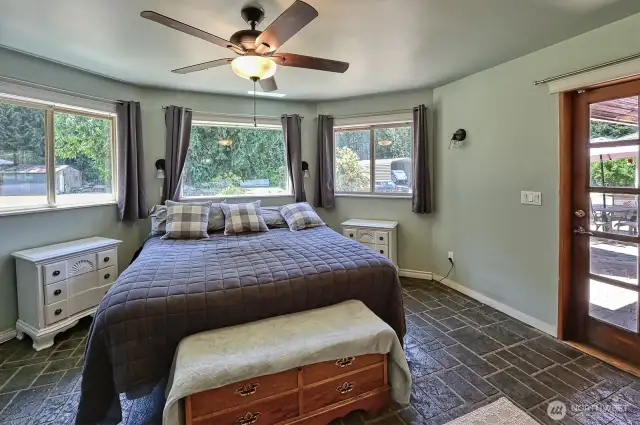 Primary bedroom with door to front patio, 2 walk-in closets and full en-suite bathroom.
