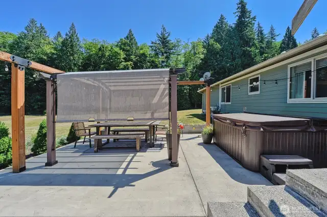 Gorgeous back patio with hot tub and more space to soak in the peacefulness of this property.