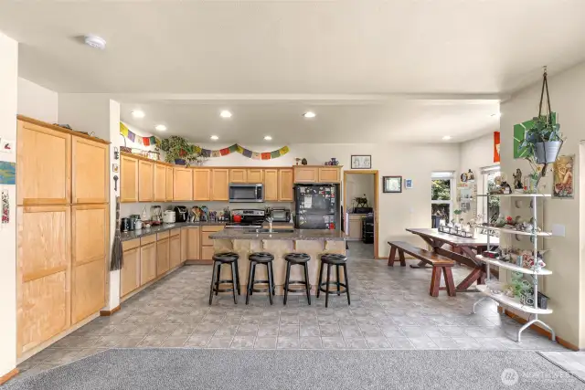 A large pantry is featured on the left. The kitchen features laminate floors and counters.