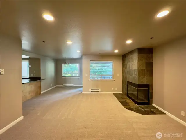 Entryway opens into living, dining, and kitchen areas