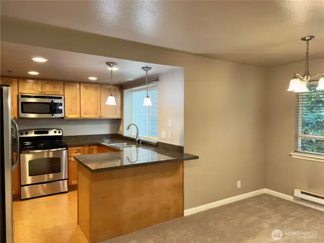 Kitchen, eating bar, and dining area