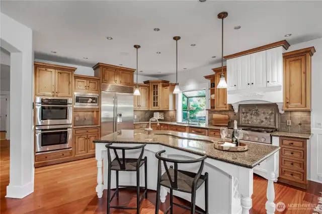 Gorgeous Granite tops and full height tile backsplash. All Stainless Steel appliances including a Sub Zero fridge, 6-Burner Range, double ovens. Love the "lazy River" veggie sink in the island!!!