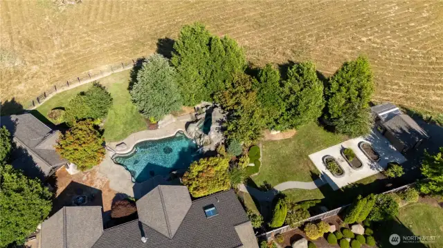 Great Aerial shot of the Backyard. To the right is a greenhouse and pump house.