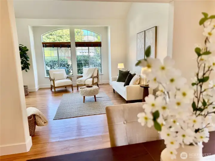 Beautiful sight lines throughout the main level showcase the home's elegant windows and seamless flow from living room to dining area.