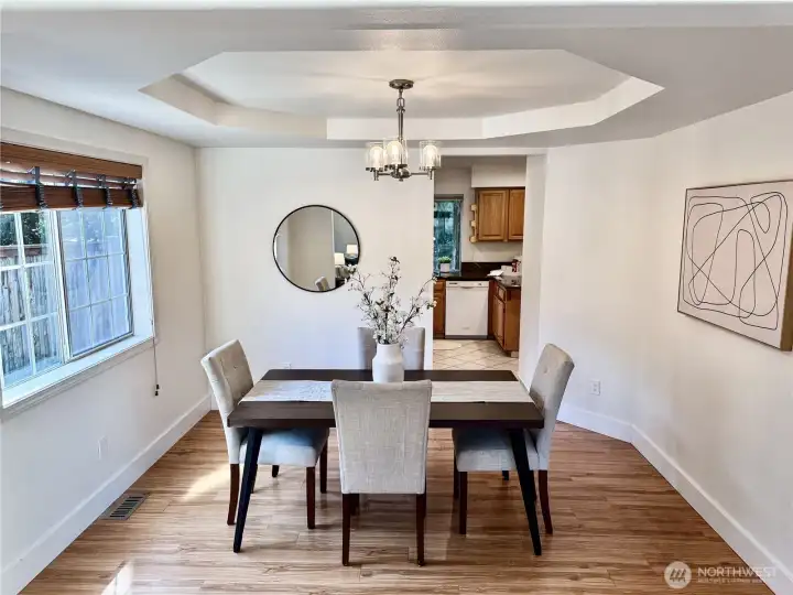 The formal dining area showcases beautiful flooring and an open layout that connects perfectly with the kitchen and living spaces.