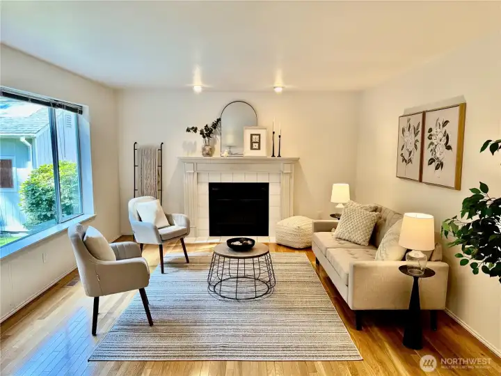 Cozy up by the beautiful white fireplace with classic mantel styling, a stunning focal point that anchors this open-concept living space and provides warmth for gatherings year-round.