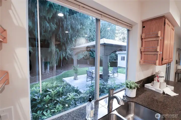 Lush backyard is enjoyed from your kitchen window.