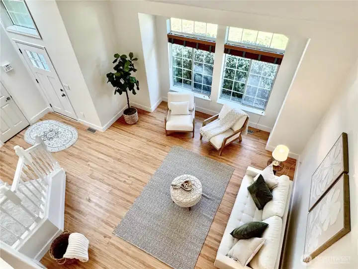 The heart of the home features dramatic two-story ceilings, beautiful architectural details, and perfect integration of living, dining, and kitchen spaces.