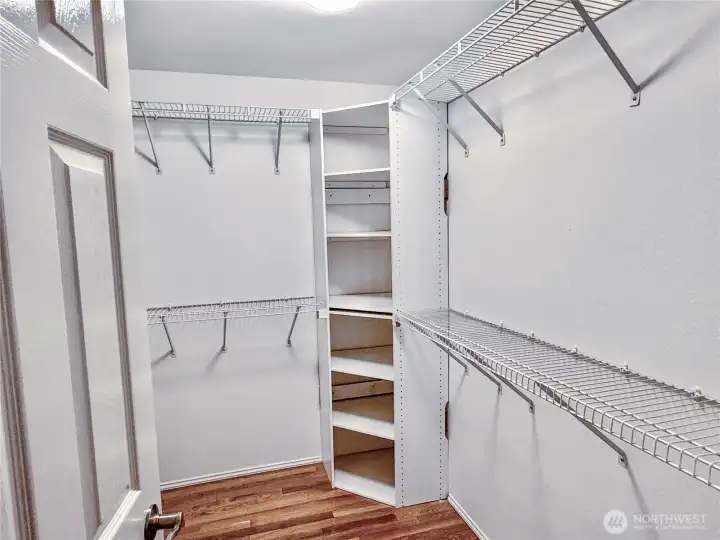 Generous walk-in closet with custom wire shelving system provides exceptional storage and organization for the primary suite.