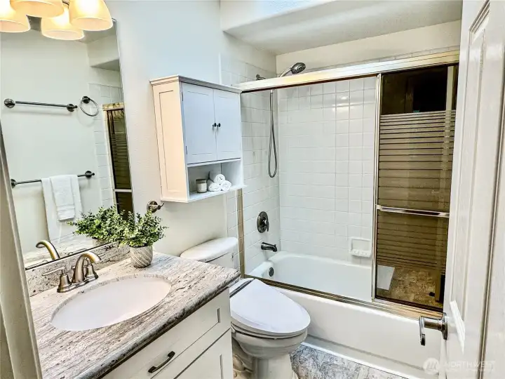 Full bathroom on the second floor with extra storage.