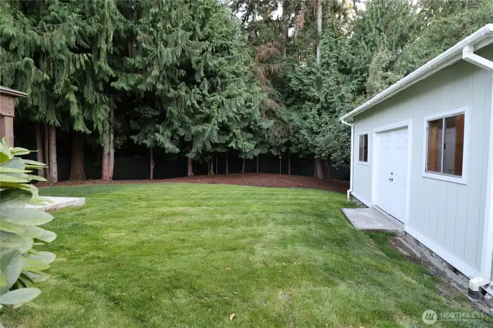 Impressive oversized storage shed with windows, skylights, and double-door access provides exceptional functionality.