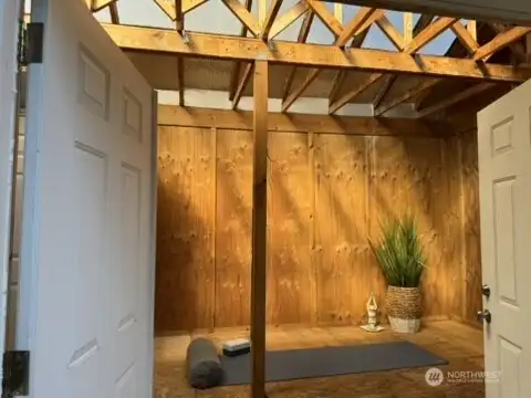 Bonus oversized storage shed with soaring cathedral ceilings, skylights, and double-door entry creates a bright, airy workspace perfect for hobbies, crafts, or additional storage needs.