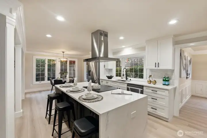Expansive kitchen with oversized island, bar seating, and premium stainless appliances.