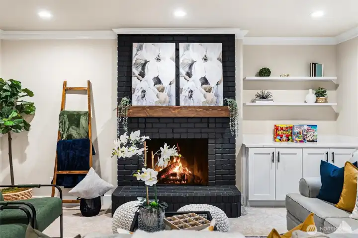 Fireplace focal point with custom surround and curated shelving details.