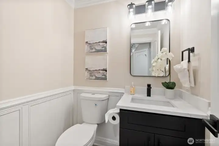 Stylish main-level powder room with modern vanity and updated finishes.