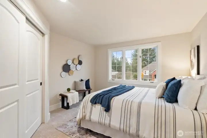 Secondary bedroom with soft natural light and neutral palette.